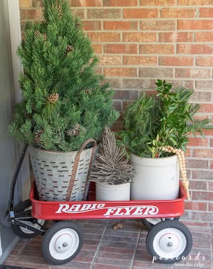 Cozy Farmhouse Christmas Display with red wagon and potted greenery