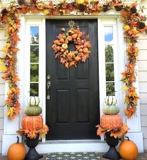 autumn porch with door fall leaves garland, pumpkin topiary and fall wreath