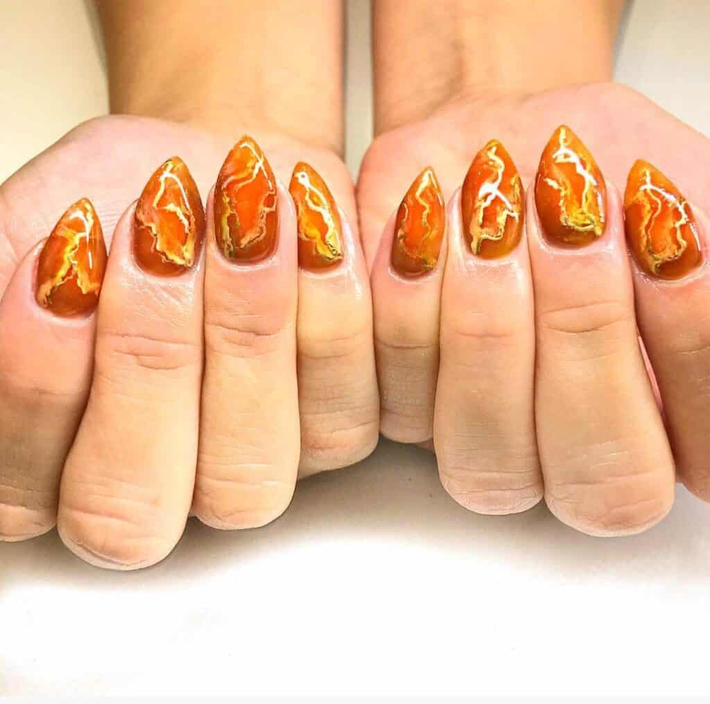 Discover the charm of amber nails with a variety of creative designs, from gel to acrylic styles. Find inspiration for your next manicure.